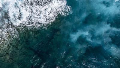 Large waves of turquoise rough sea from above